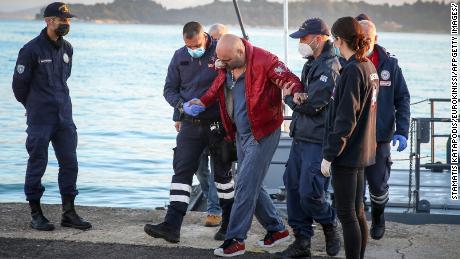 Um passageiro resgatado chegou ao porto de Corfu na sexta-feira, depois que centenas de pessoas foram evacuadas do navio.