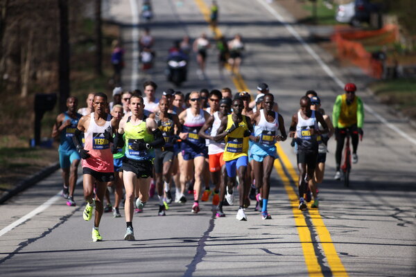 CJ Albertson (29) and Bethwell Yegon (14) lead the elite men during the 2022 Boston Marathon.