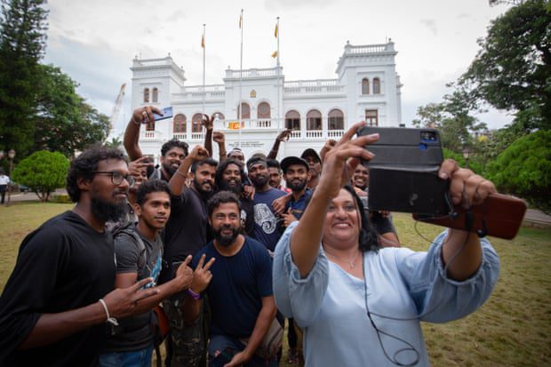 Manifestantes posam para uma selfie em grupo enquanto devolvem o gabinete do primeiro-ministro às autoridades governamentais.